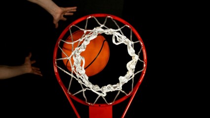 Detail of basketball ball hitting the basket, top view. Isolated on black background. © Jag_cz