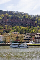 Fototapeta premium Heidelberg with houses, forest, ship and castle, taken in spring over the river Neckar