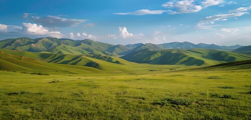 Naklejka premium A breathtaking expanse of rolling green hills and towering remote mountains stretching into the horizon