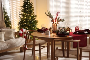 Christmas table setting with stylish dishware and festive decor indoors