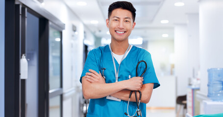 Nurse, asian man and happy with arms crossed at hospital for medical service, healthcare and career...