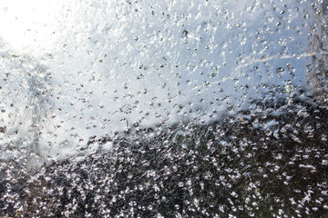 Close up of a ice sheet against blue spring sky, abstract  patterned structure