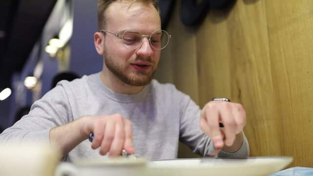 man eating salad with fork and knife