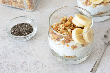 a close up of Yogurt Parfait with Granola, Banana and Chia Seeds