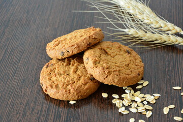 Delicious Homemade Oatmeal Cookies with Wheat and Oats on a Wooden Surface