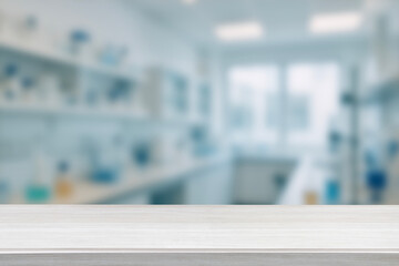 Empty Wooden Table lab table blurred scientific laboratory background. workspace for research, biotechnology, medical science, innovation and healthcare concept. For display or montage your products