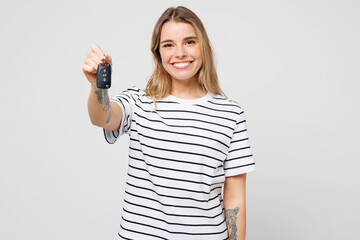 Young happy cheerful woman she wear striped t-shirt casual clothes hold car key fob keyless system...