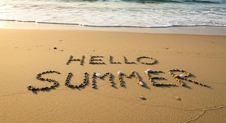 Hello summer written in sand on beach with seashells by ocean waves.