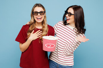 Young fun couple two friends women wearing red casual clothes 3d glasses together watch movie film...