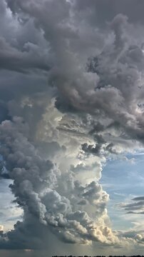 Massive storm cloud forming - towering dark clouds collide 