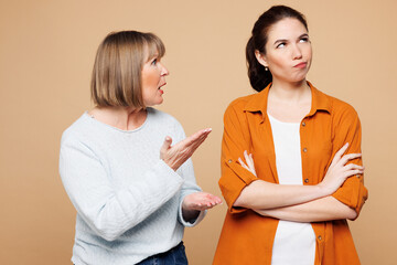 Elder sad mad angry dissatisfied parent mom 50s years old with young adult daughter two women...