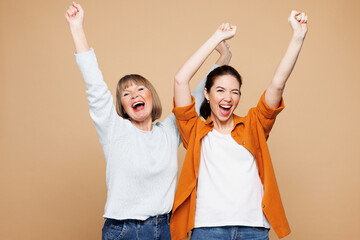 Elder parent mom 50s year old with young adult daughter two women together wear casual clothes do...
