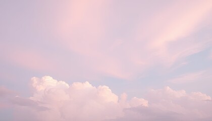 Obraz premium Pastel Pink and Blue Sky with Fluffy White Clouds at Sunset