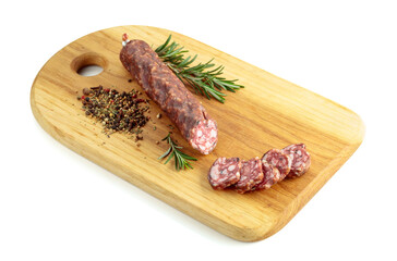 Sliced dry cured sausage on a cutting board.