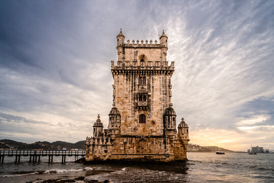 Belem Tower at sunset casts a golden glow on the Tagus River in beautiful Lisbon, Portugal.