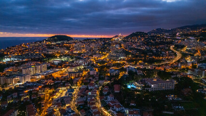 City lights twinkle against the backdrop of a deepening twilight sky in a coastal paradise