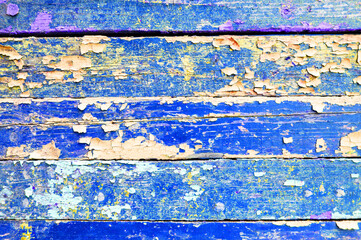 Texture background of dark blue and light orange peeling paint on the wooden background, chipped...