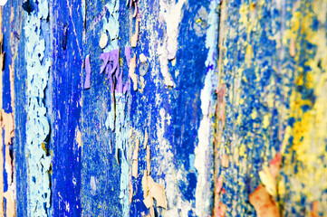 Texture background with wooden surface covered with peeling paint of blue color, peeling paint...