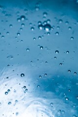 Blue water bubbles rising underwater with light and wave reflections in minimal abstract composition.