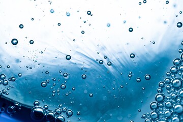Cluster of water bubbles forming abstract pattern on right side of frame with soft blue underwater background.