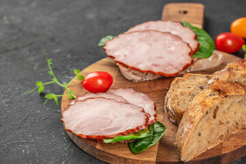 Sandwich with ham and vegetables on a dark background. top view. copy space for text