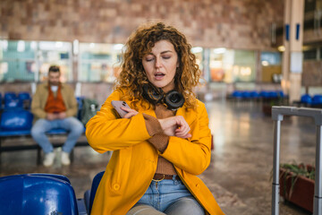 bored impatient curly hair woman wait for train on the station