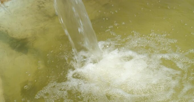 Fill the pool with water.Store water in a pond to use for watering crops.Water from underground is drawn up for agriculture.