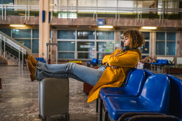 curly hair woman fall a sleep while wait for train on the station