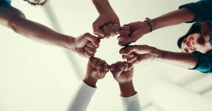 Business, people and hands with fist bump in circle for team building, company solidarity or office community. Low angle, group and closeup together for staff support, synergy or employee integration