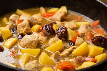 A rich chelnt with potatoes, beans, onions, meat, spices and dates is stewed