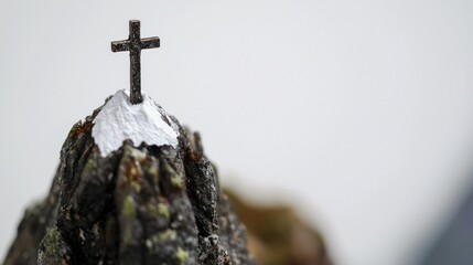 Cross atop snowy mountain peak; faith, hope, winter background; spiritual imagery