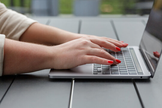 Closeup of businesswoman using laptop working remotely in a garden park background focusing on business efficiency in a natural outdoor workspace - Powered by Adobe