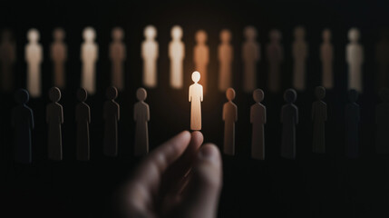Spotlight on one human among many, chosen by a hand, ideal candidate concept