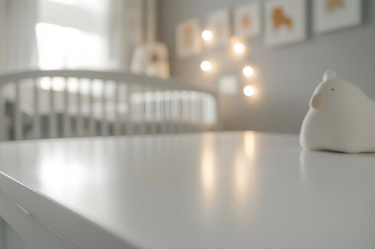White table nursery dresser with crib in background