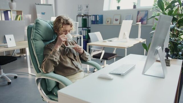 A man and woman savor coffee breaks in a busy office setting
