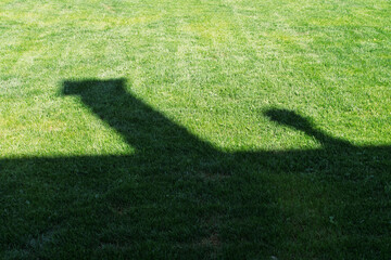 Shadow of a house on a well-maintained green lawn. A conceptual image suitable for home security, real estate, outdoor safety, landscaping, and DIY content. 