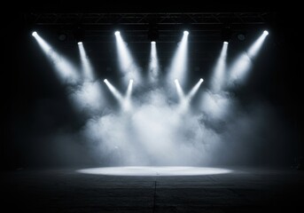 Stage with multiple spotlights shining down through smoke creating a dramatic theatrical atmosphere