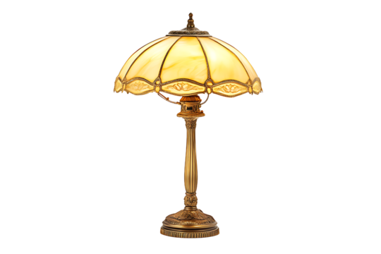 Illuminated vintage table lamp with a golden stand and a yellow shade on a black background