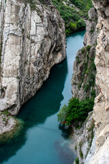 View from above of a turquoise river in a canyon. The Sulak River flows at the bottom of a canyon in Dagestan. Sulak Canyon on a summer day, view from above.