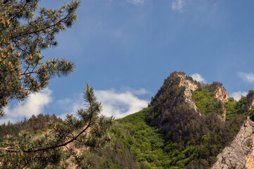 Silhouette of mountain peaks on a clear day. A chain of mountain peaks against a blue sky without...