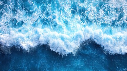 Fototapeta premium A bird's-eye view of turbulent waves crashing on the shore, revealing the raw power of the ocean as it stretches endlessly towards the horizon. The azure expanse above provides a breathtaking 