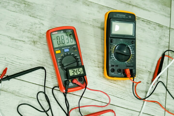 Two multimeters and thermometer on the table. Measuring instruments