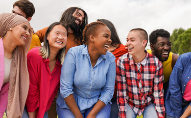Group of multiracial people enjoy day at city park - Diverse young friends having fun outdoor