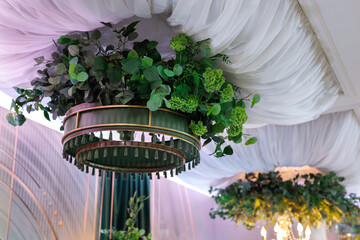 Wedding Tent: Luxurious wedding decor with elegant green accents and crystal chandeliers.