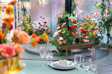Wedding decoration with bright fresh flowers in close-up on a stand. Decoration of the banquet hall.