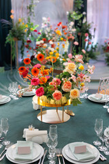 Wedding decoration with bright fresh flowers close-up. Table decoration.