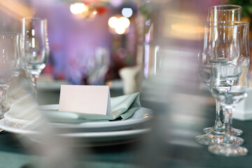 Elegant table setting with a blank card for the name of the guest at the wedding banquet.