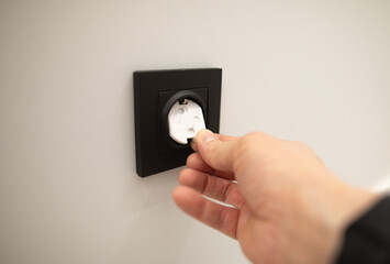 Safety cover is inserted into outlet, indicating a precaution intended to protect children from...