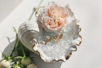 Wedding rings in a shell-shaped box at a wedding exit ceremony.