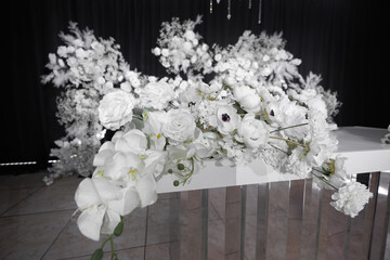 Wedding decor of flowers and crystal beads, chandeliers in the banquet hall.